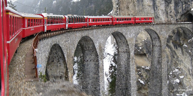 Horizonte 135.jpg - was made from the running train just leaving thefamous Landwasser Viadukt (=Bridge) of the Rhaetic Railwaysin the mountenous southeast part of Switzerland. The bridgewas constructed 1901-1902, known as an architectural wonderand is still in use. It's declared as a Unesco World Heritagesince 2008.   click here for Google Maps View   Position: N46°40'50" E09°40'34", elev. 1030m/3400ft Camera: Canon Ixus 80 IS, date: 10/03/2009