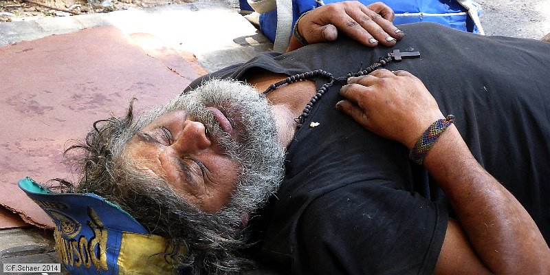 Horizonte 203.jpg - an obvious catholic tramp take a nap on a quiet corneralong a sidewalk in the Boca-quarter in Buenos Aires, Argentina.   click here for Google Maps View   Position: S34°38'00" W58°21'40", elev.13m/40ft Camera: Lumix TZ41, date: 10/01/2014, 11:42 local time