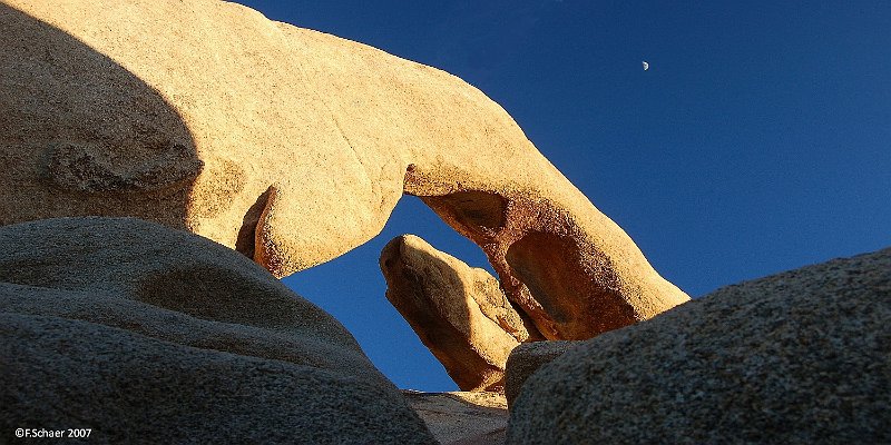 Horizonte 223.jpg - the impressive Granite-arch near the White TankCampground in Joshua Tree National Park in eastern Californiaseen from an unusual angle to catch the Halfmoon in the same pic.   click here for Google Maps View   Position: N33°59'13"/W116°00'59", elev.1175m/3865ft Camera: Nikon D50 at 31mm, polfilter, date:27/11/2006, 16:01pm