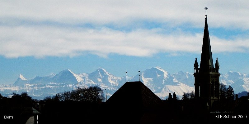 Horizonte 25.jpg - shows the silhouette of Berne, the capital of Switzerland. In the background the wellknown peaks of the Berner Alpen, from left to right: Finsteraarhorn, Eiger, Moench, Jungfrau, all above 4000m/13200 ft.   click here for Google Maps View   Position (camera): N46°57'00" E07°26'00" Elev. 525m/1725 ft, distance to the peaks: 70 km