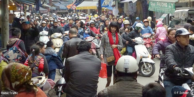 Horizonte 27.jpg - shows a part of the daily traffic on a street crossing in Hanoi Vietnam. Most of the crowds use a motorbike for their work and there are about 40 millions of those bikes in Vietnam. Without any traffic-lights or traffic control everybody find a way through the mess. That's real road courtesy, impossible in the western world...   click here for Google Maps View   Position about: N 21°02'11" E 105°51'03" Elev. 15m/50ft Camera: Lumix TZ20