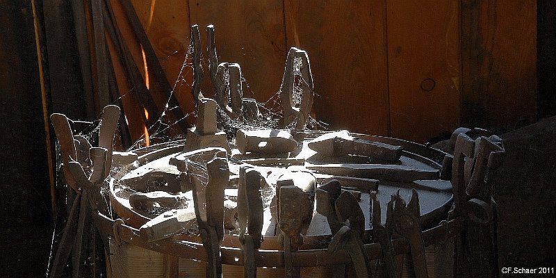 Horizonte 298.jpg - Spiderwebs decorates the old forging-tools in aBlacksmith's shop in historic town of Barkerville, in theBackcountry of British Columbia, Canada.   click here for Google Maps View   Position: N 53°04'04"/ W 121°30'58", elev. 4120ft/ 1250mCamera: Nikon D200, Sigma 18-200,date 09/09/2011, 11:05am