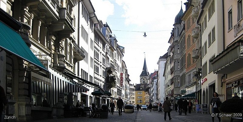 Horizonte 40.jpg - made on the "Rennweg" in Zurich/Switzerland, Rennweg is in the heart of Zurich adjacent to the old part of the city, wellknown for stolling and shopping. The church in the center is St.Peter-Church with one of the biggest clock-face in Europe. The church's history begins 853 aD. with extensions and renovations 1230-1700.   click here for Google Maps View   Positions road: N47°22'23" E08°32'23" Elev. 416 m/2280 ft. Camera: Canon Ixus