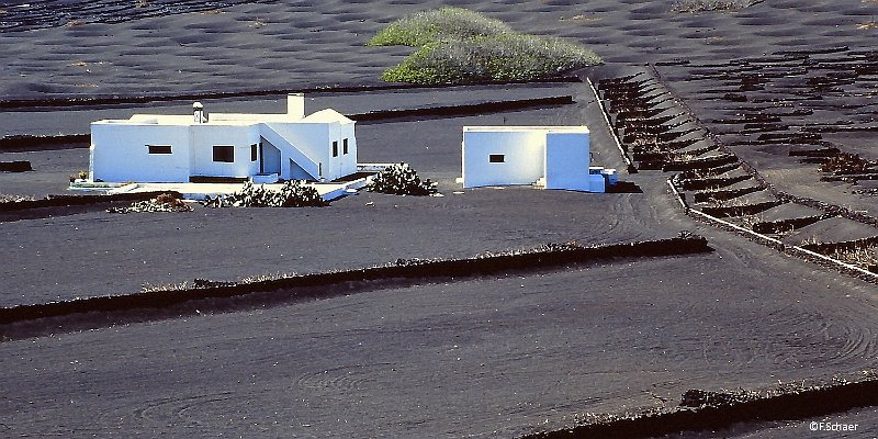 Horizonte 60.jpg - an impressive view on a typical farmhouse in the center of the volcanic island of Lanzarote in the Canary Islands (Spain). The islanders cultivate grapes in little depressions in the lava-ground and produce excellent wines with a special flavour. I made this pic long ago on Ektachrome slide film and digitalized it with a cheap *ion-scanner. Therefore the quality of the picture is not totally satisfying.   click here for Google Maps View   Approx. position: N29°00'54" W13°38'13"  elev. 280m/920ft Camera: Nikon F3, 1,4/50mm lens, converted with *ion-scanner 5MB